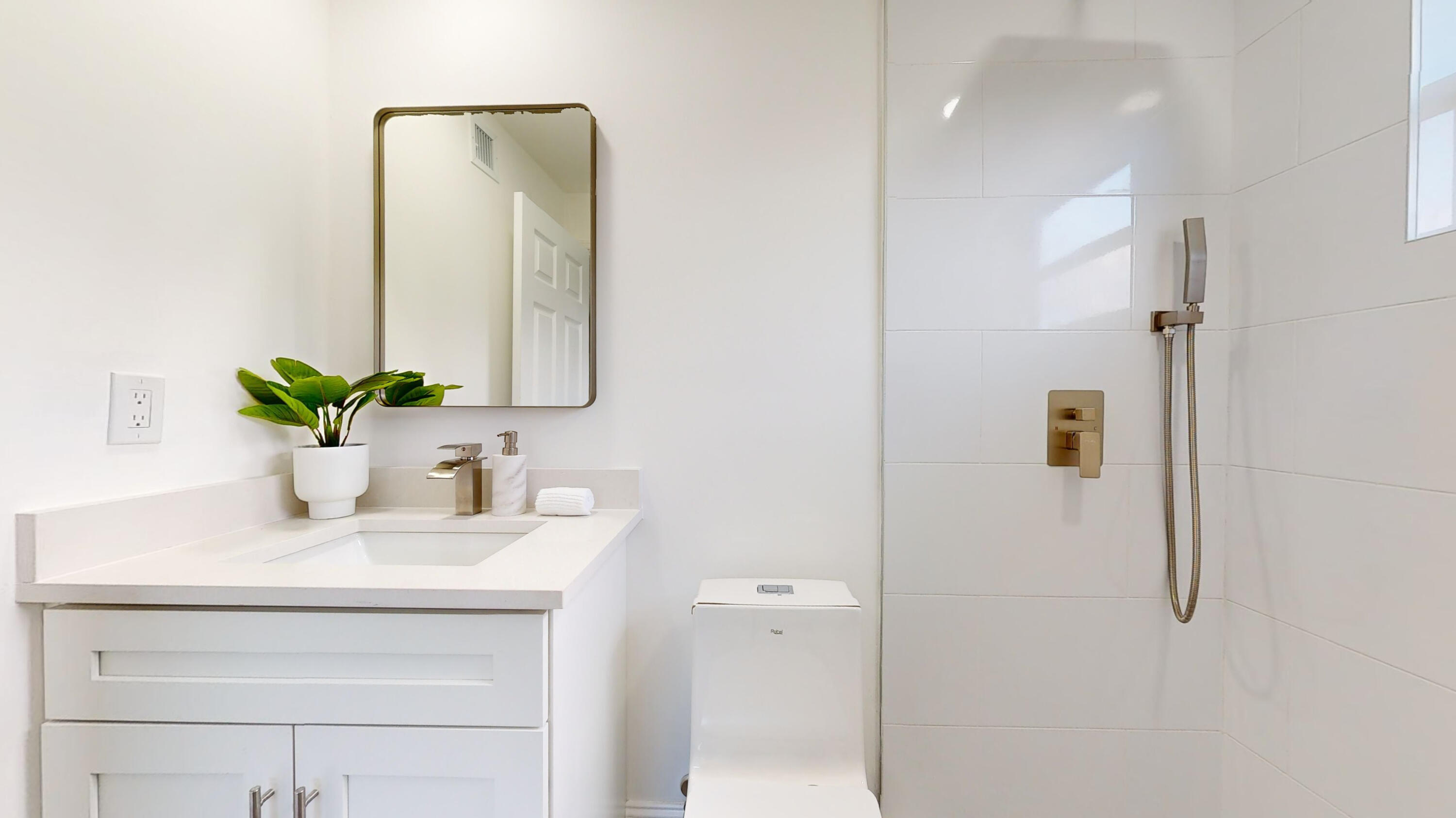 6674 4th Street Jupiter, FL 33458 - Photo 9 of 21 a bathroom with a sink vanity and a mirror