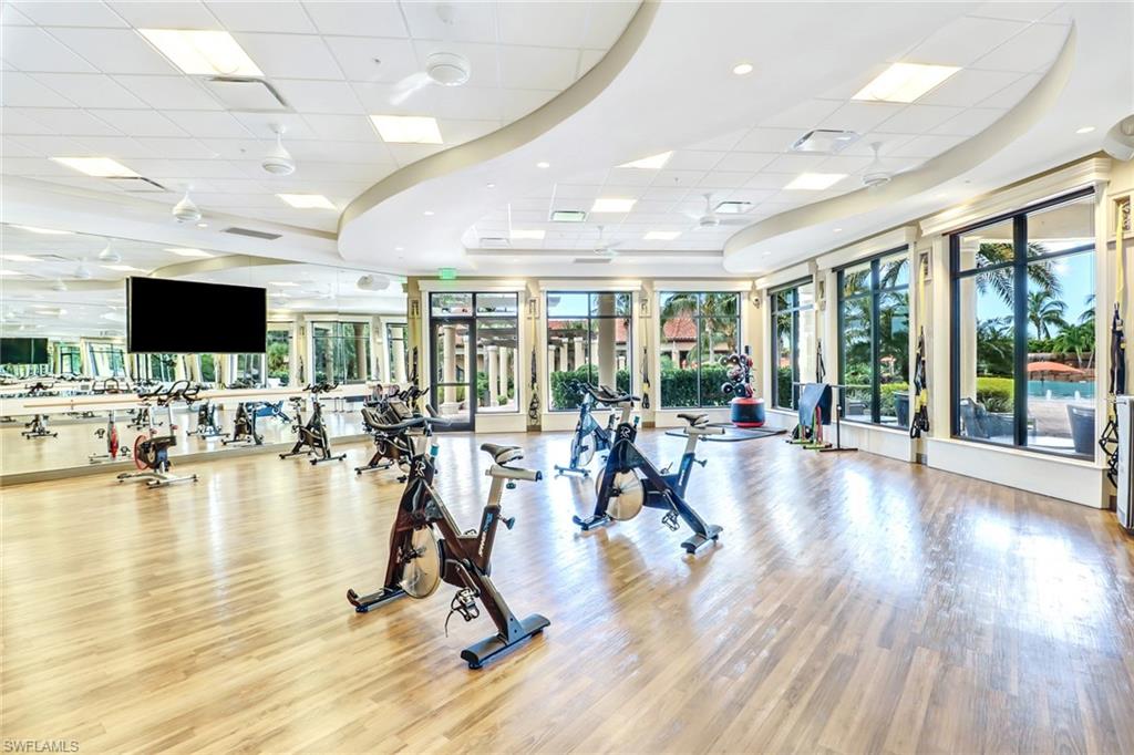 9731 Acqua Court, Unit 537 Naples, FL 34113 - Photo 21 of 25 a view of a room with gym equipment and floor to ceiling window