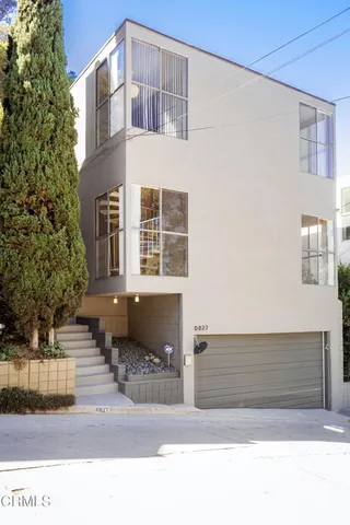 a black and white photo of a house with a outdoor space