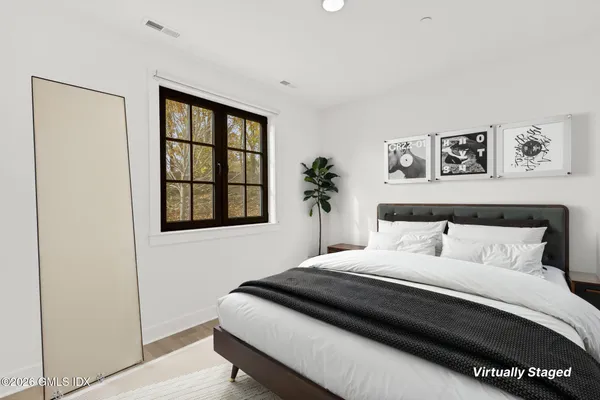 a bedroom with a large bed and a window