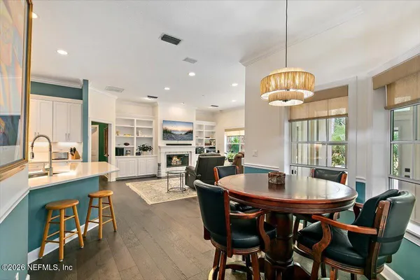 a view of a dining room with furniture window and wooden floor