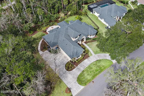 an aerial view of a house with outdoor space and pool