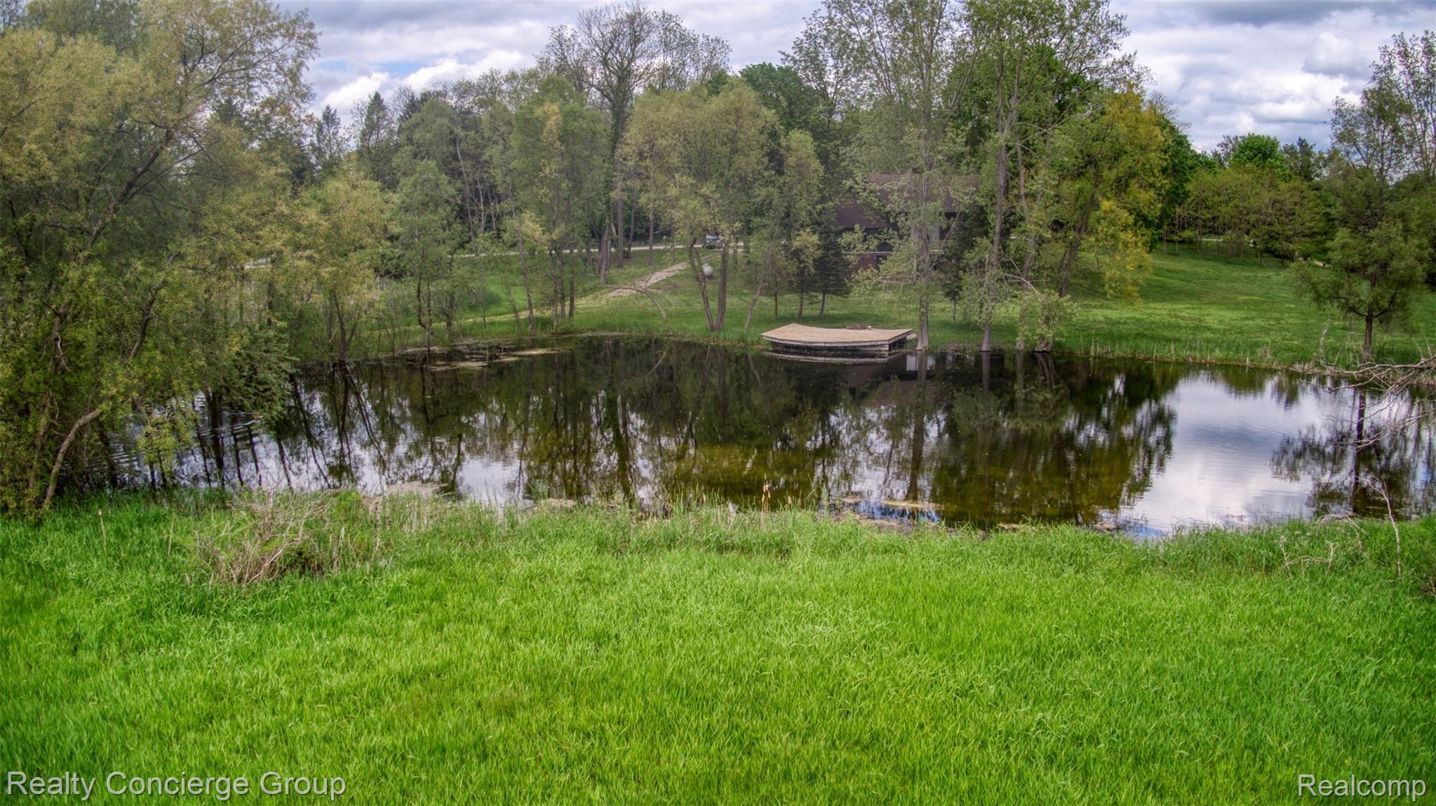 2110 East Clyde Road Howell, MI 48855 - Photo 32 of 44 Pond is stocked with bass, perch and sunfish for the fishing fanatic