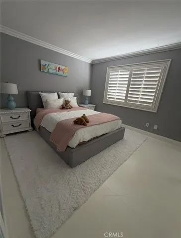 a spacious bedroom with a bed and window