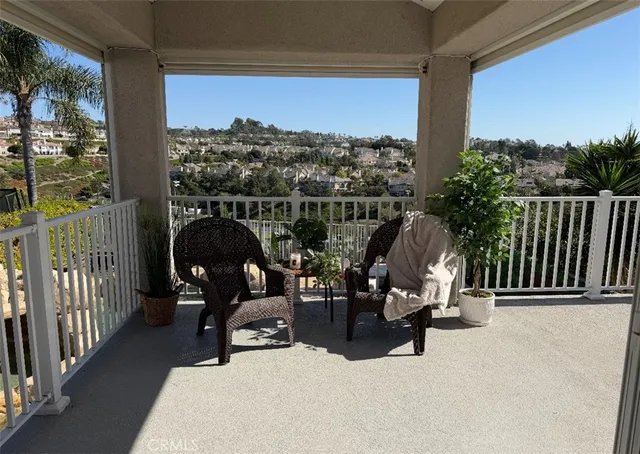 a view of a balcony with chairs