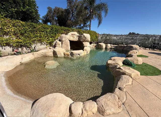 a view of swimming pool with a table and chairs