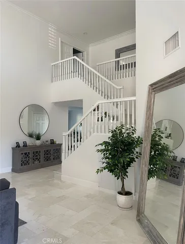 a view of staircase with furniture and potted plant