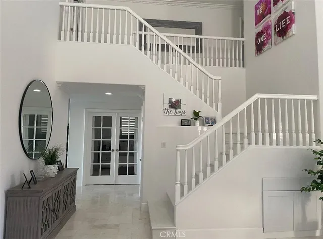 a view of staircase with white walls and a window