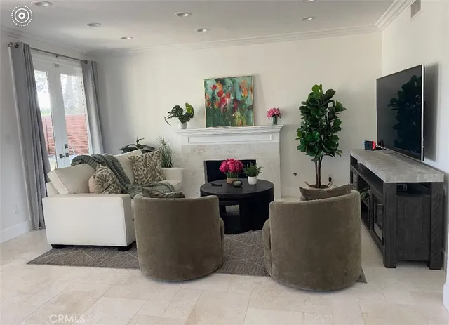 a living room with furniture a flat screen tv and a fireplace