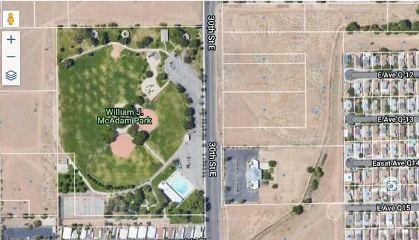 an aerial view of a residential apartment building with a tree