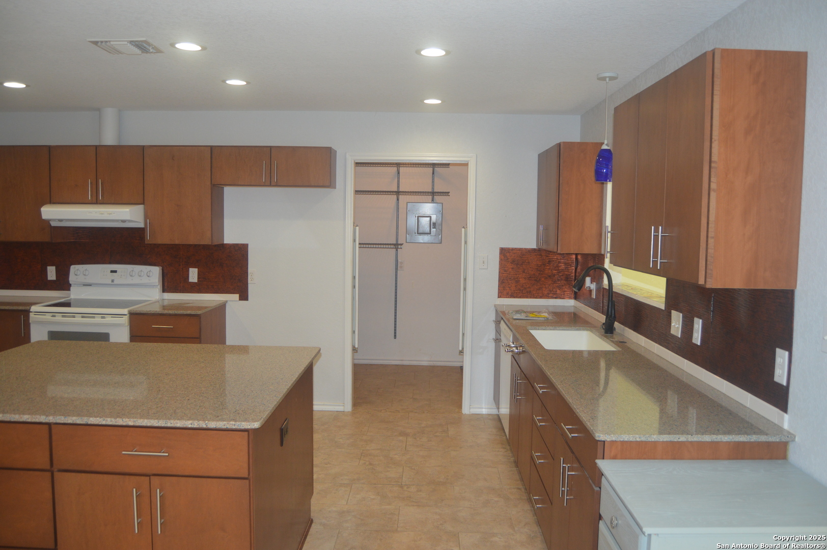 14847 Lytle Somerset Street Lytle, TX 78052 - Photo 14 of 42 a kitchen that has a sink and a stove in it