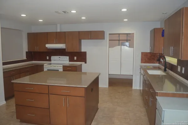 a kitchen with a sink stove and refrigerator