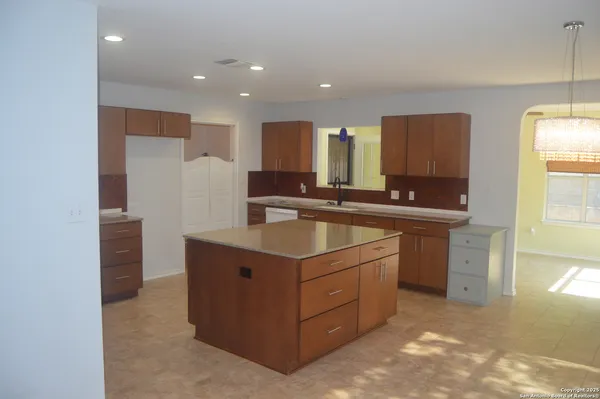 a view of kitchen and hall with a flat screen tv