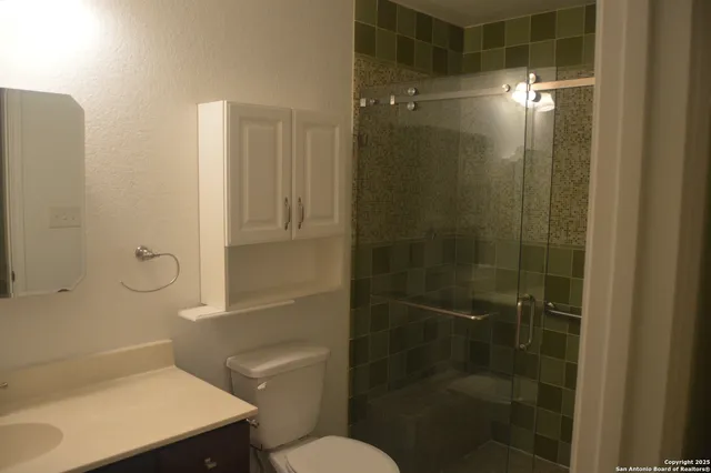 a bathroom with a glass shower door