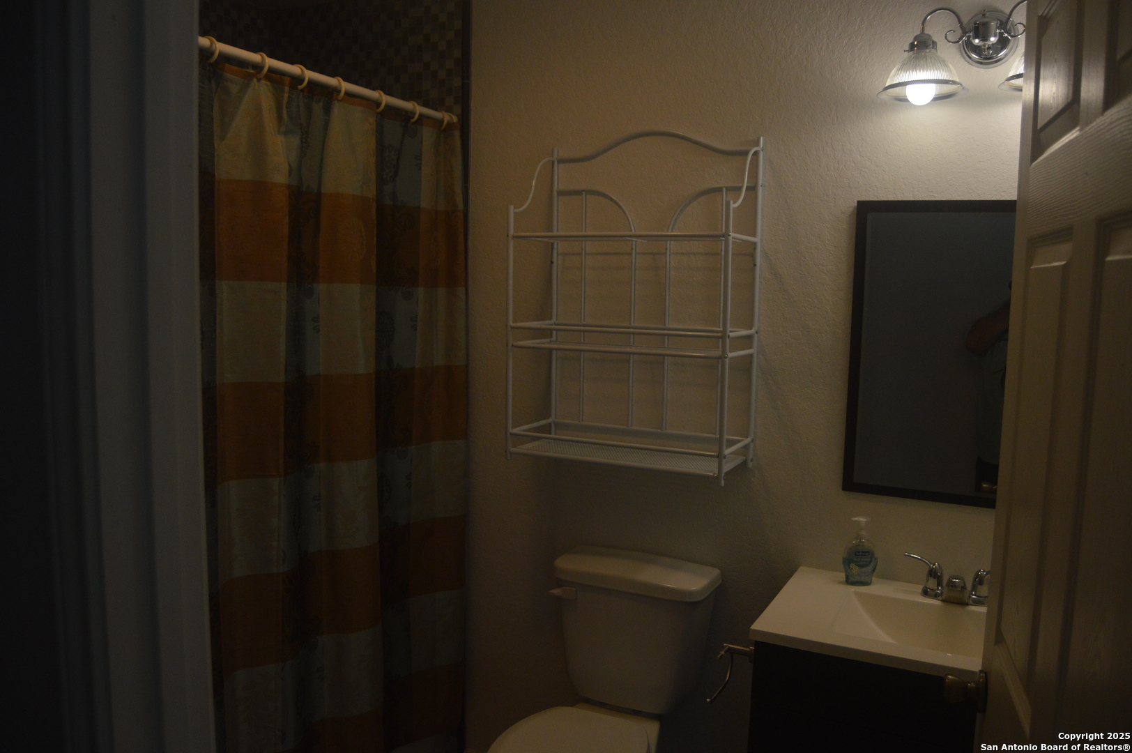 14847 Lytle Somerset Street Lytle, TX 78052 - Photo 26 of 42 a bathroom with a sink toilet and shower