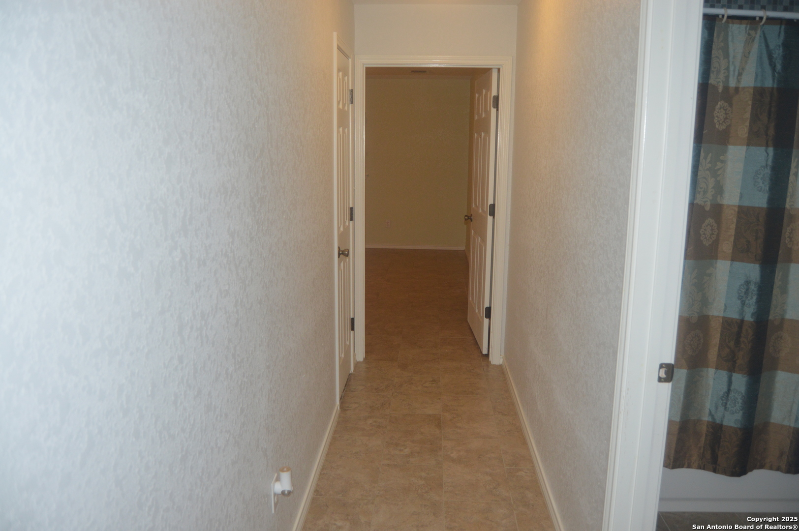 14847 Lytle Somerset Street Lytle, TX 78052 - Photo 27 of 42 a view of a hallway with a wooden floor