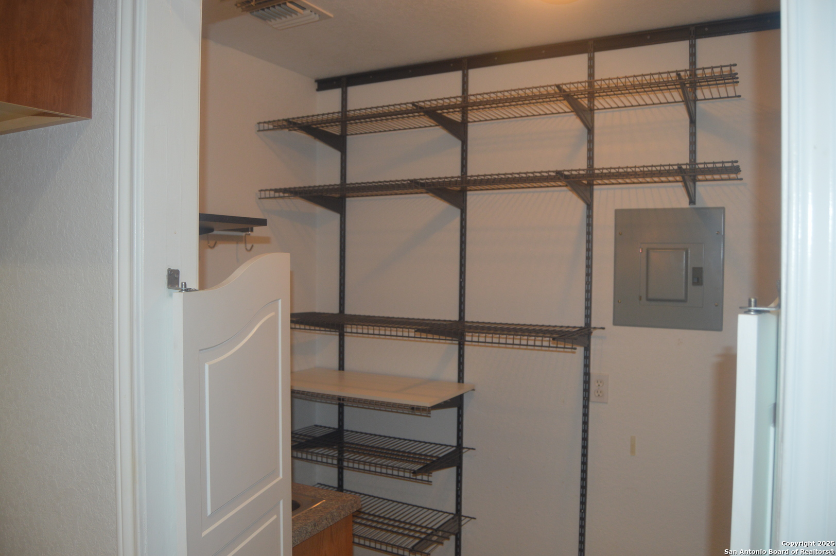 14847 Lytle Somerset Street Lytle, TX 78052 - Photo 6 of 42 a view of an empty room with racks on the wall