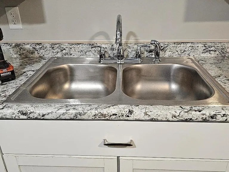 800 Davol Street, Unit 1 Fall River, MA 02720 - Photo 3 of 14 a kitchen with a sink and wooden vanity