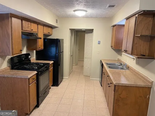 a kitchen with a stove and a refrigerator