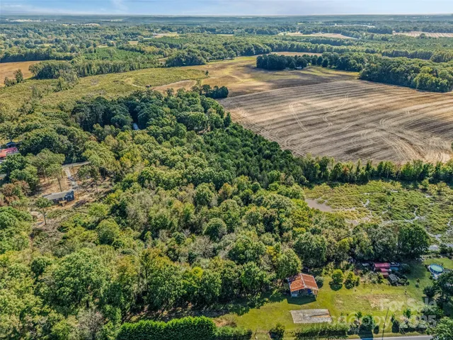 an aerial view of a houses with yard