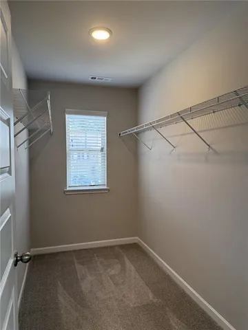 a view of a room with rack on the wall and a window