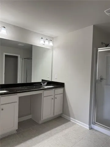 a large bathroom with a sink and a mirror