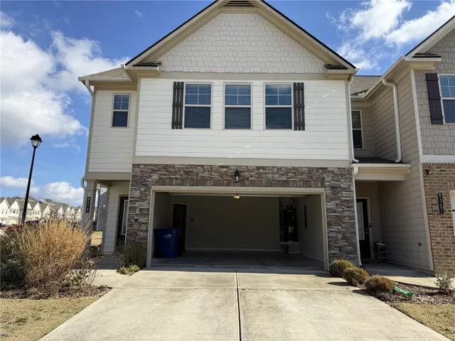 a front view of a house with a garage