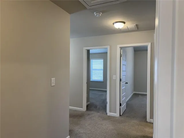 an empty room with closet and mirror