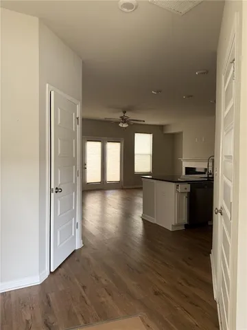 a view of a kitchen with a sink and wooden floor