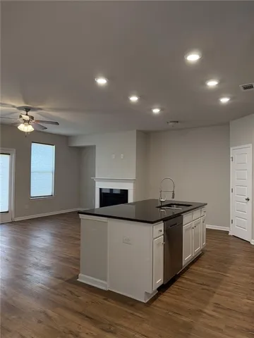 a kitchen with stainless steel appliances granite countertop a sink and stove top oven
