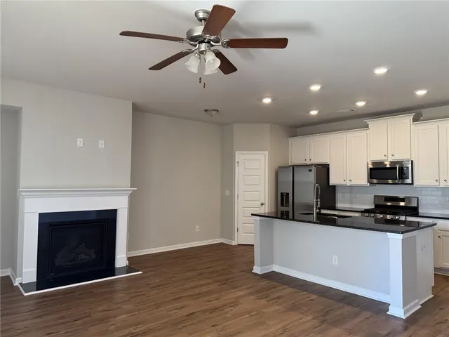 a kitchen with stainless steel appliances a refrigerator sink and microwave
