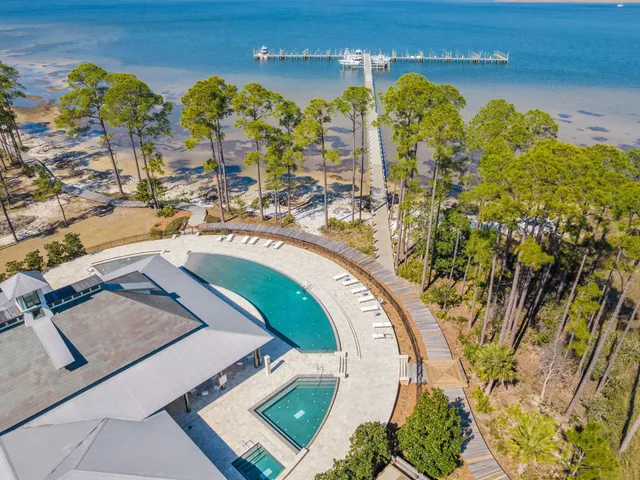 an aerial view of a swimming pool with outdoor seating