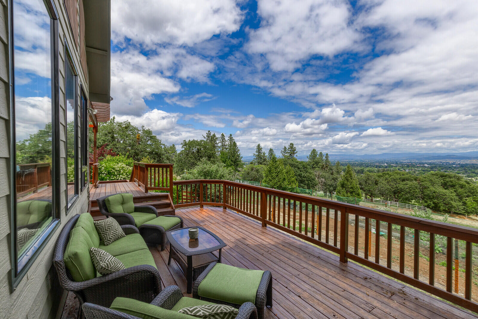 3181 Old Stage Road Central Point, OR 97502 - Photo 58 of 78 a view of a patio with couches chairs potted plants and wooden floor