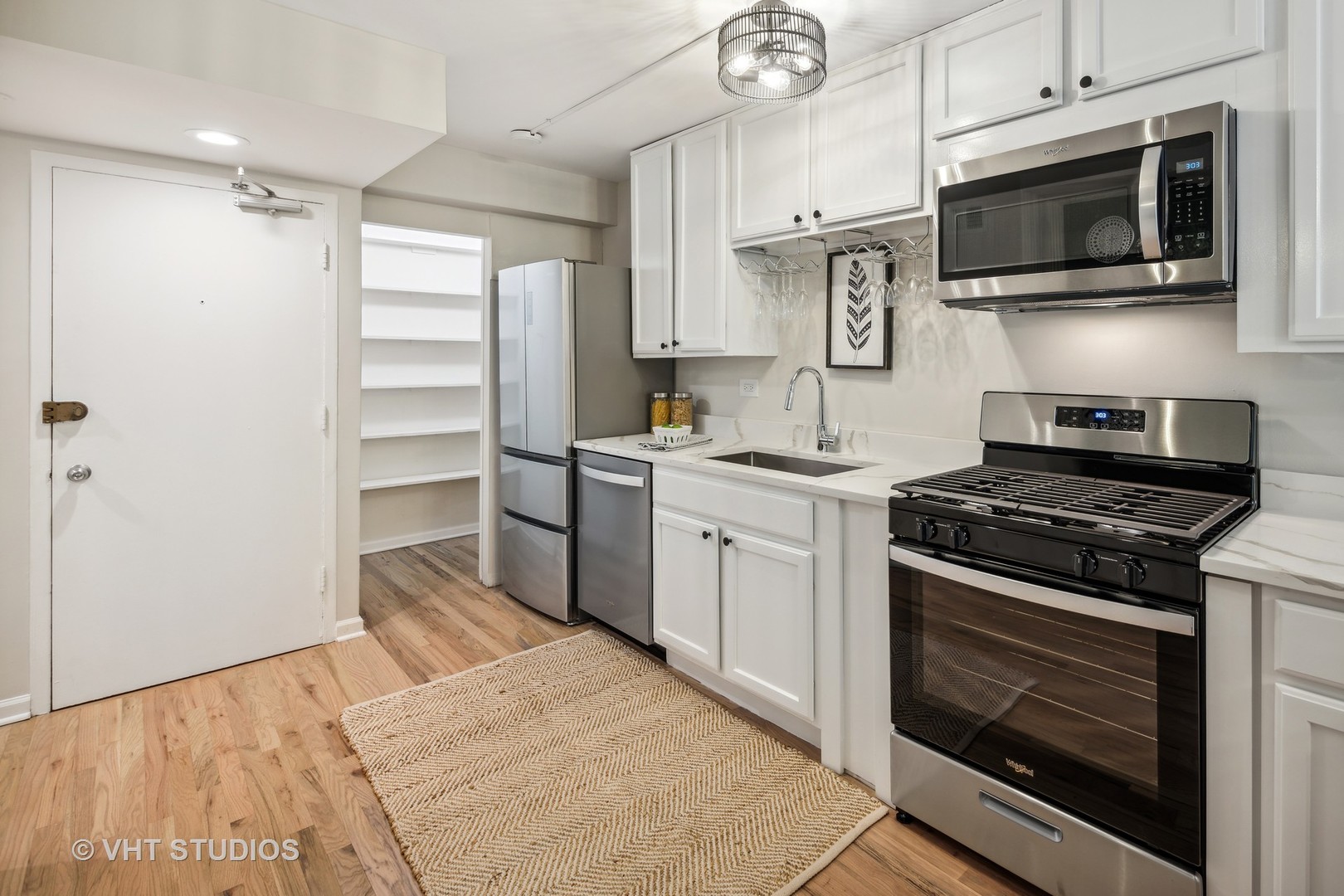 1540 North State Parkway, Unit 3D Chicago, IL 60610 - Photo 7 of 15 a kitchen with stainless steel appliances a stove microwave and sink