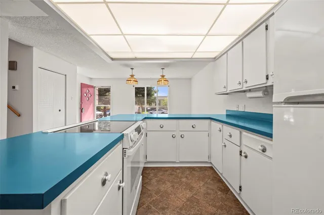 a kitchen with granite countertop a sink cabinets and window