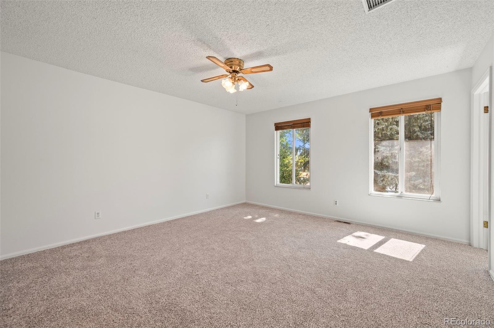 4420 South Vivian Way Morrison, CO 80465 - Photo 16 of 50 an empty room with windows and fan