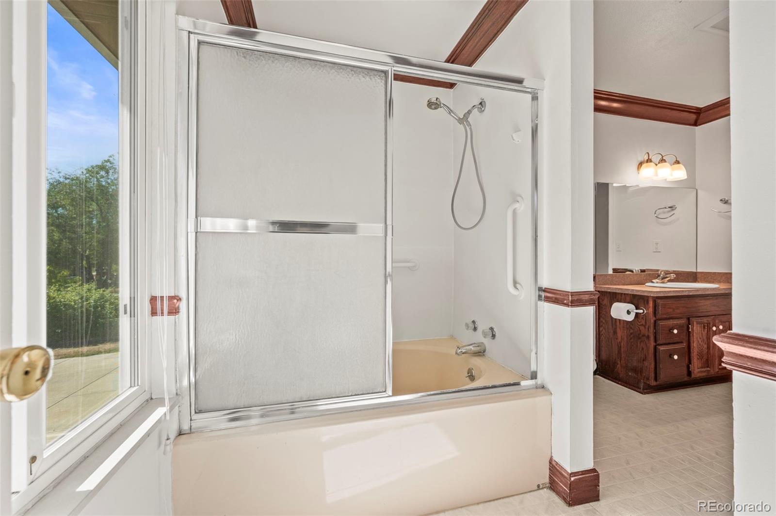 4420 South Vivian Way Morrison, CO 80465 - Photo 20 of 50 a bathroom with a tub and shower