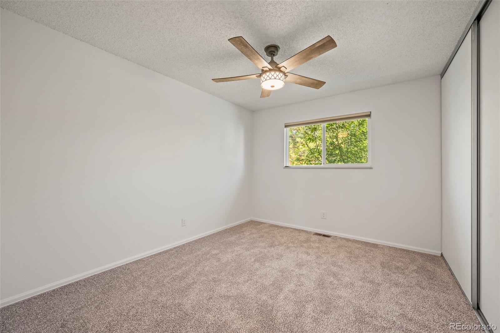 4420 South Vivian Way Morrison, CO 80465 - Photo 23 of 50 an empty room with windows and fan