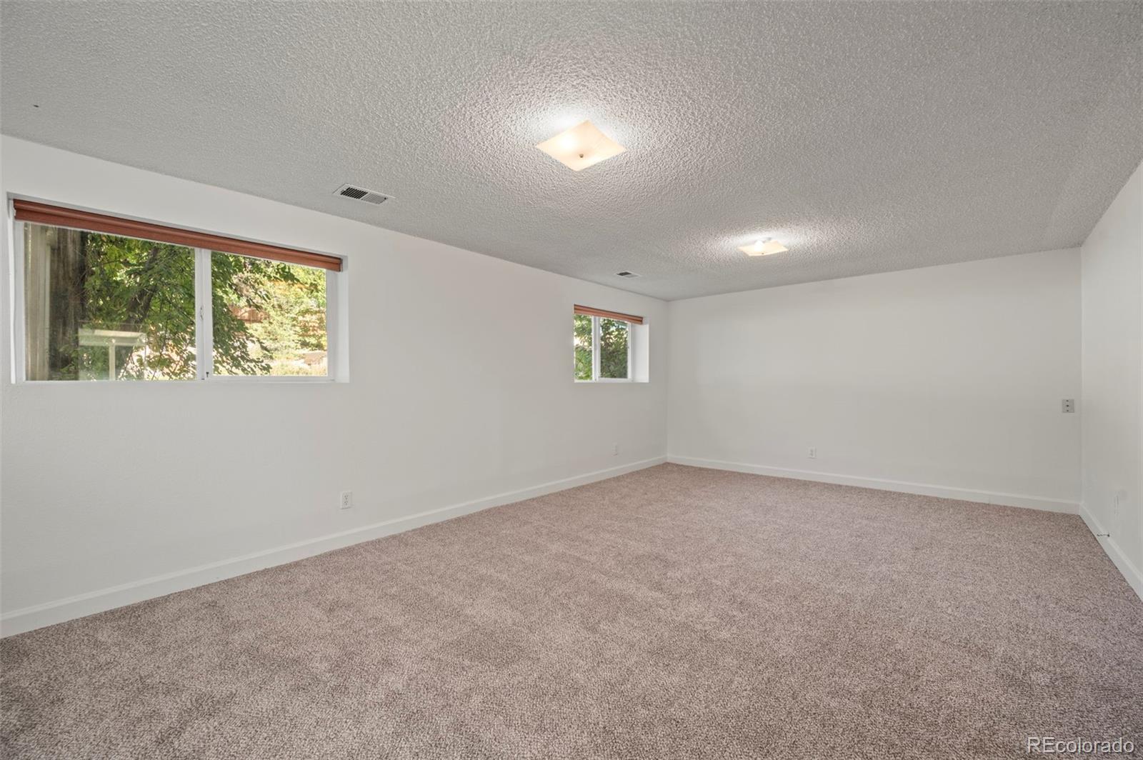 4420 South Vivian Way Morrison, CO 80465 - Photo 25 of 50 an empty room with windows