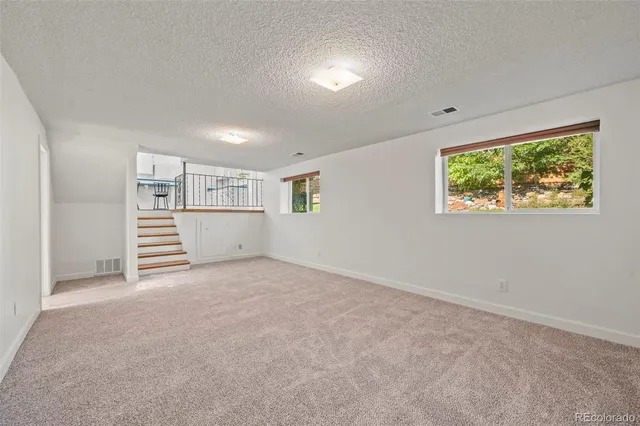 a view of a big room with windows and cabinet