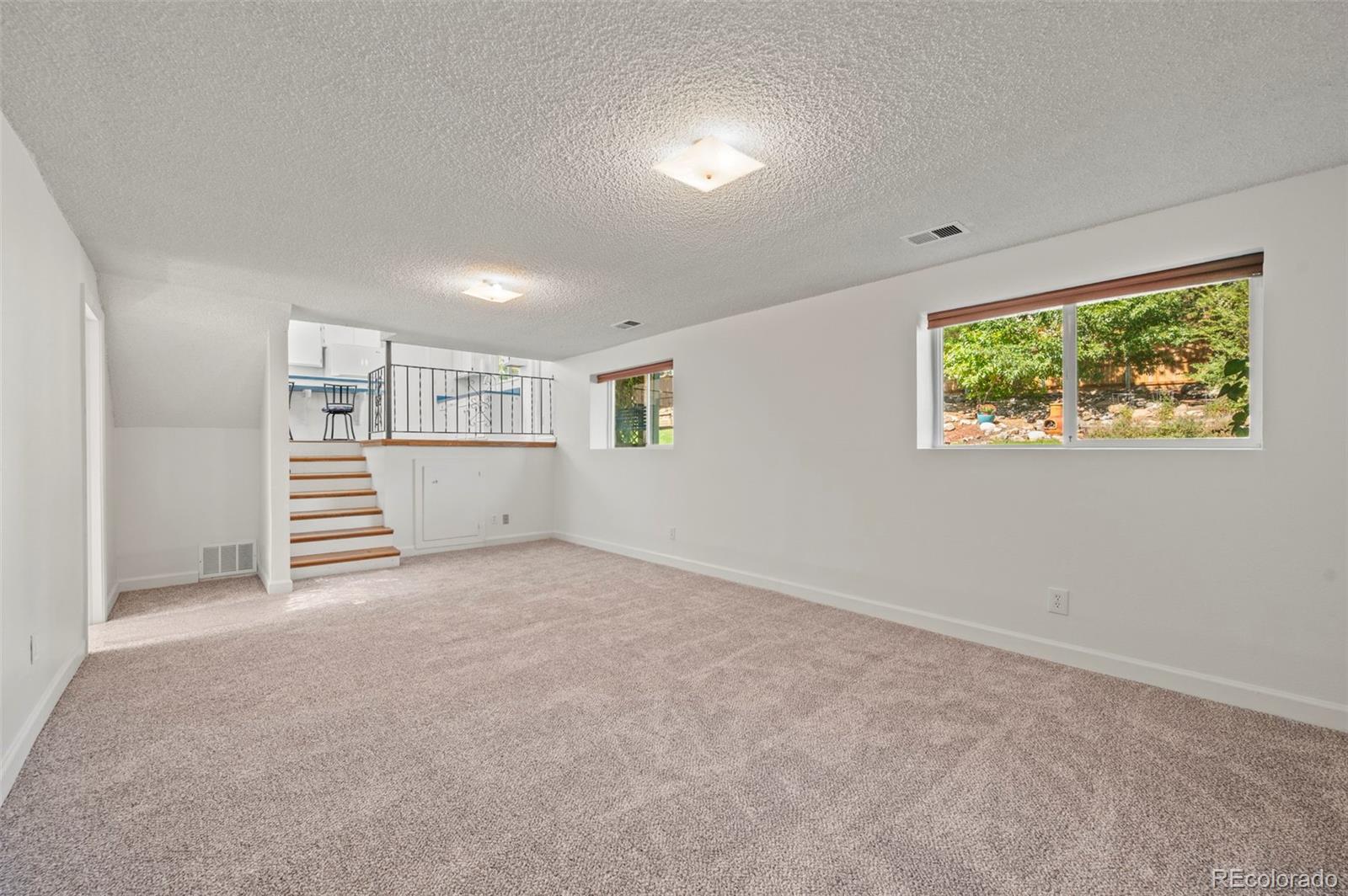4420 South Vivian Way Morrison, CO 80465 - Photo 26 of 50 a view of a big room with windows and cabinet