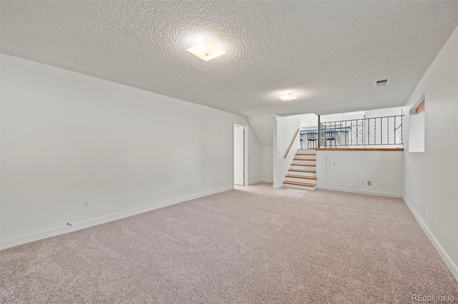 4420 South Vivian Way Morrison, CO 80465 - Photo 27 of 50 a view of an empty room with stairs and ventilation