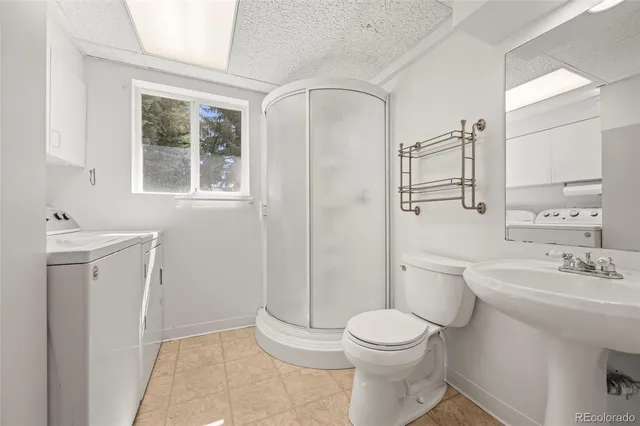 a bathroom with a toilet sink and a mirror