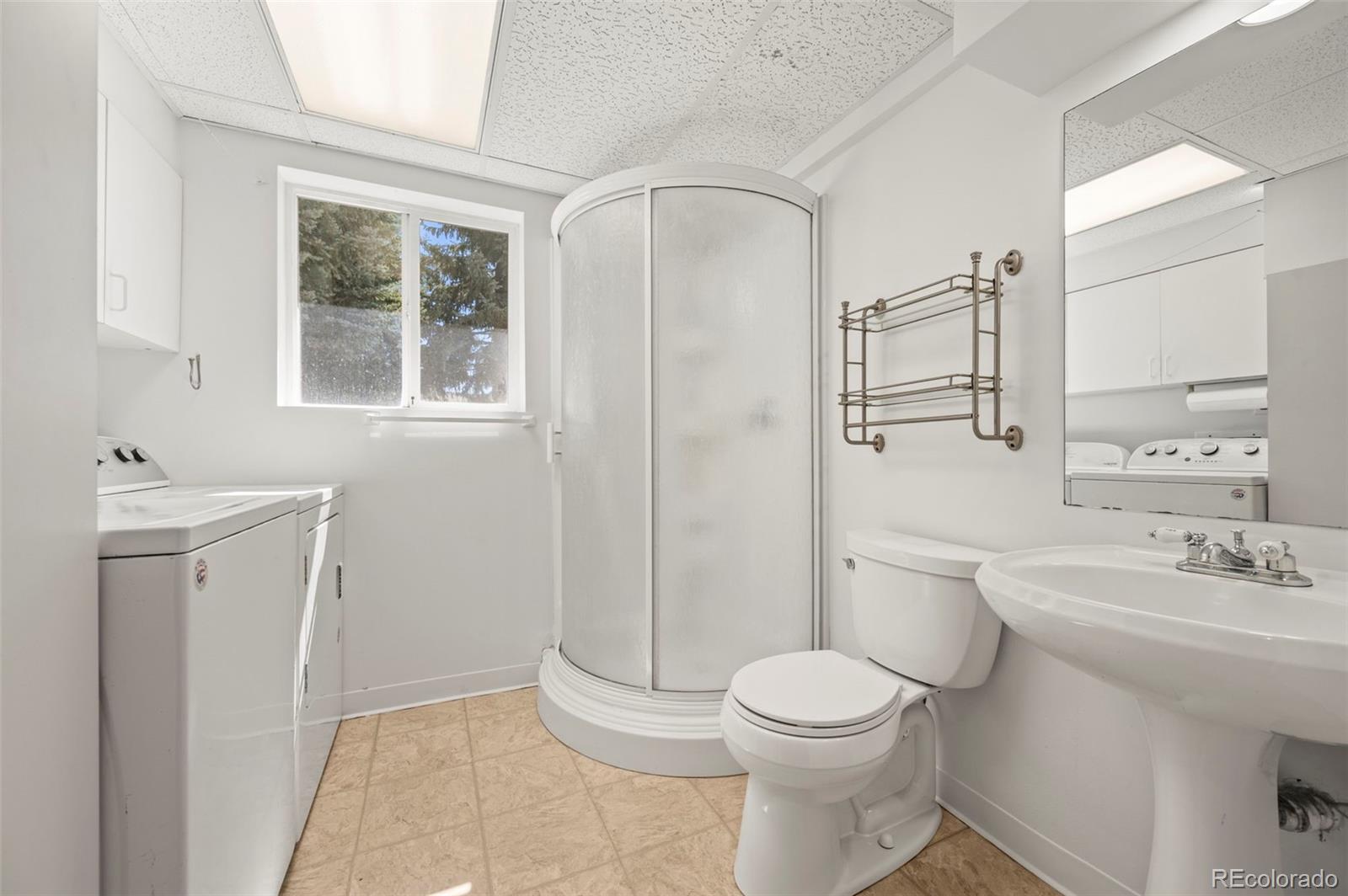 4420 South Vivian Way Morrison, CO 80465 - Photo 29 of 50 a bathroom with a toilet sink and a mirror