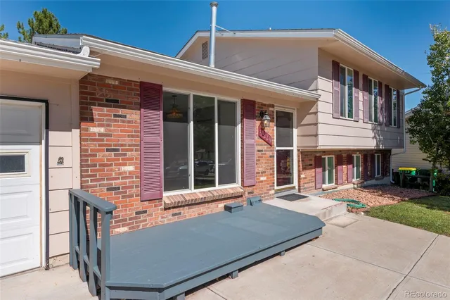front view of a brick house with a yard