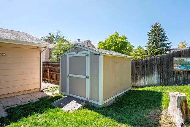 a backyard of a house with plants and tree