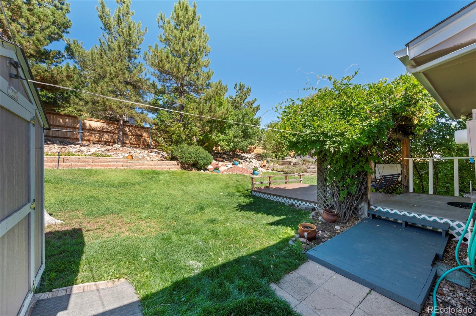 4420 South Vivian Way Morrison, CO 80465 - Photo 36 of 50 a view of a backyard with garden