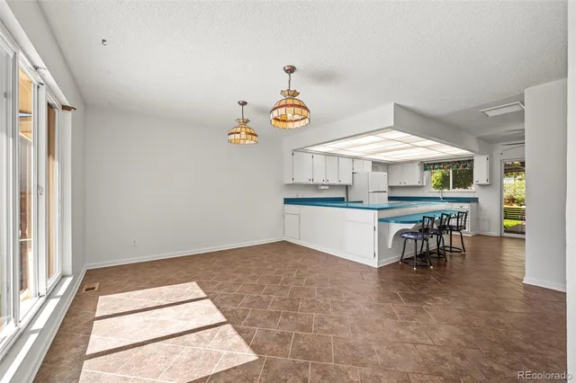 an entryway with table and chairs