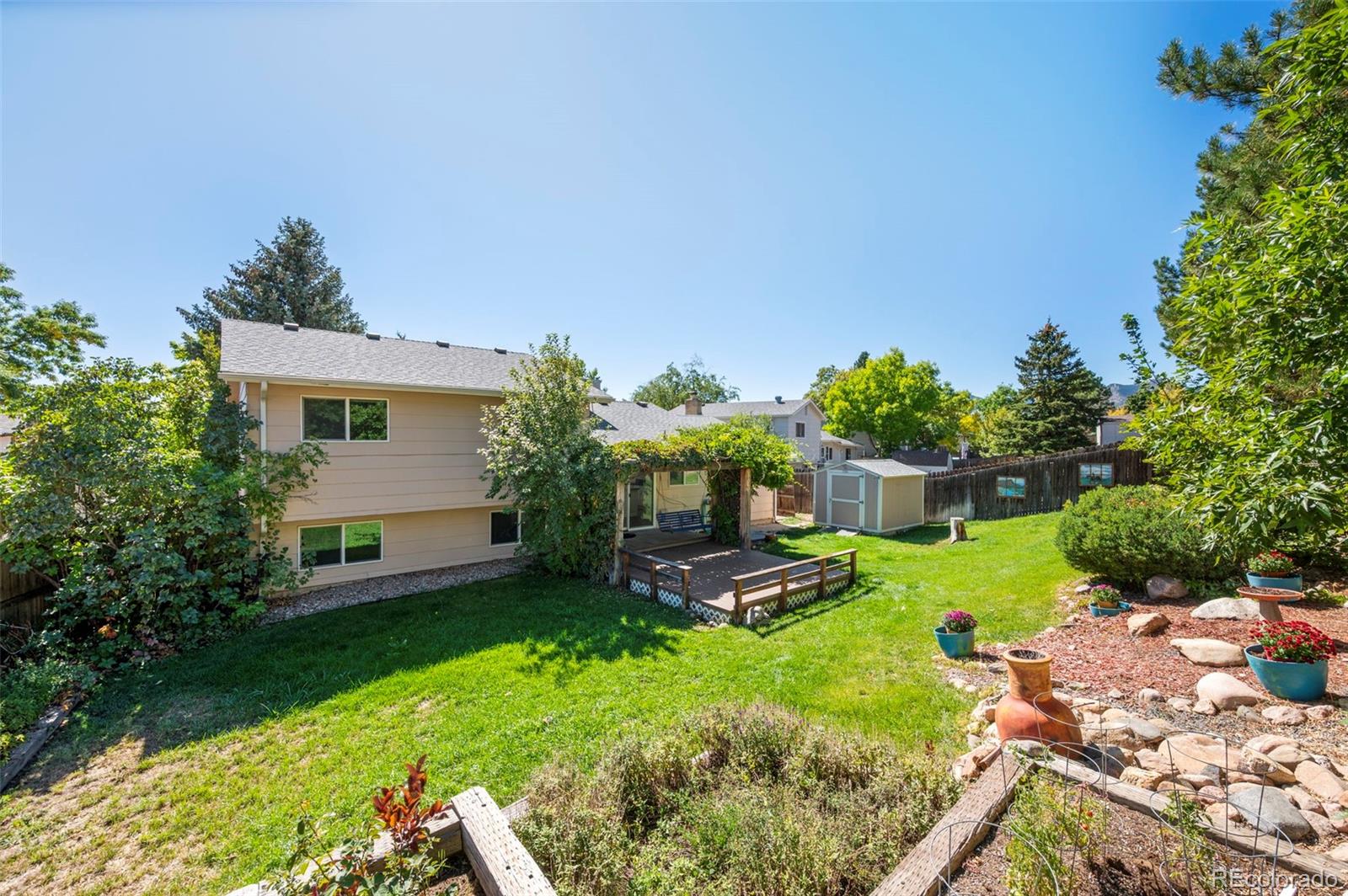 4420 South Vivian Way Morrison, CO 80465 - Photo 41 of 50 a view of a backyard with plants and a garden