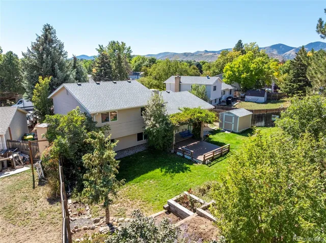 a aerial view of a house with garden space and street view